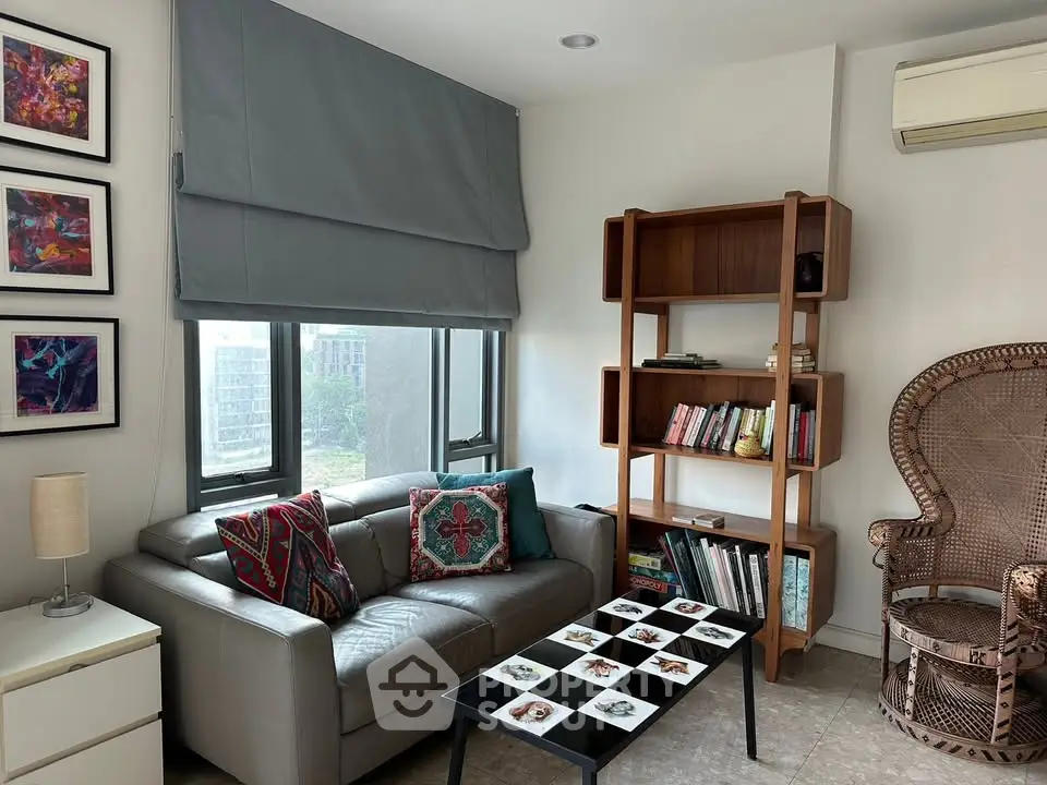 Chic living room with modern sofa, stylish bookshelf, and elegant decor in a cozy apartment setting.