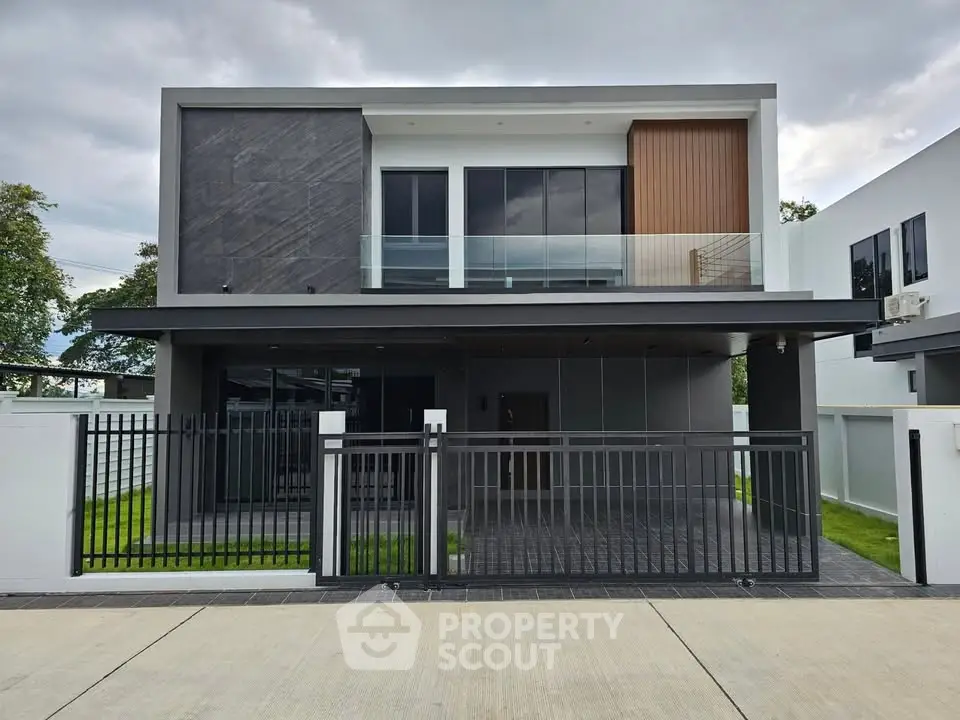 Modern two-story house with sleek design and spacious balcony in a serene neighborhood.