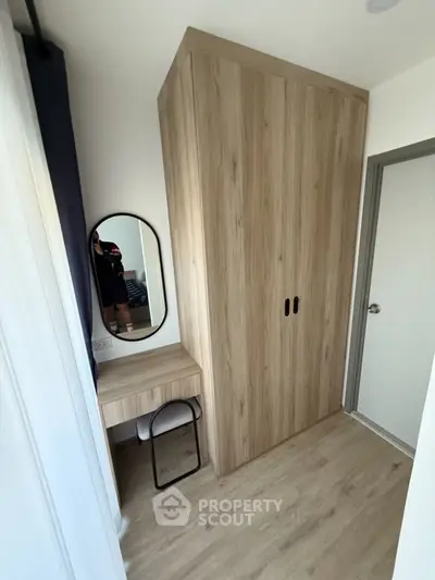 Modern bedroom corner with wooden wardrobe and vanity desk