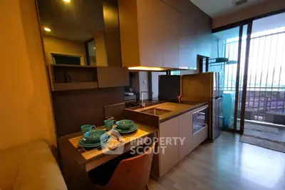 Modern compact kitchen with dining area and balcony view