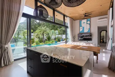 Luxurious open-plan living room with pool view and modern decor