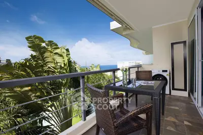 Stunning balcony with ocean view, perfect for relaxation and outdoor dining.