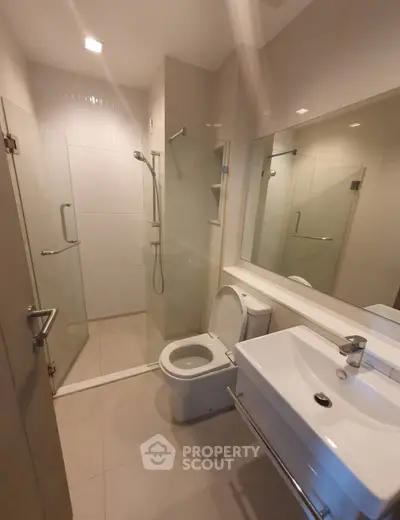 Modern bathroom with glass shower and sleek fixtures