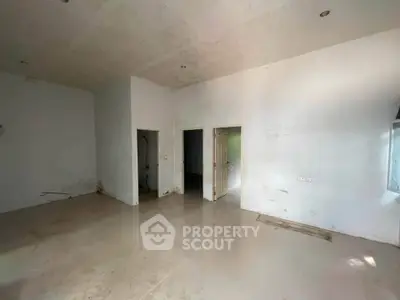 Spacious unfinished room with potential for customization, featuring high ceilings and natural light.
