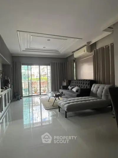 Spacious living room with modern furniture and large windows for natural light.