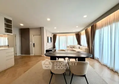 Spacious modern living room with elegant dining area and large windows