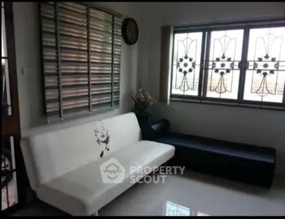 Stylish living room with modern sofa and decorative window grills