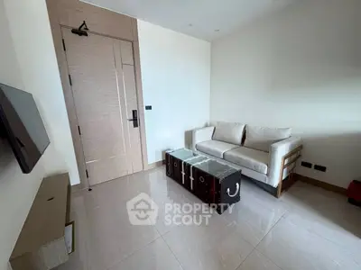 Modern living room with sleek furniture and wall-mounted TV