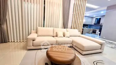 Luxurious modern living room with elegant sofa and open kitchen layout