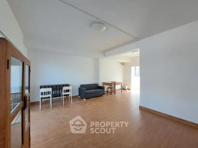 Spacious living room with wooden flooring and modern furniture