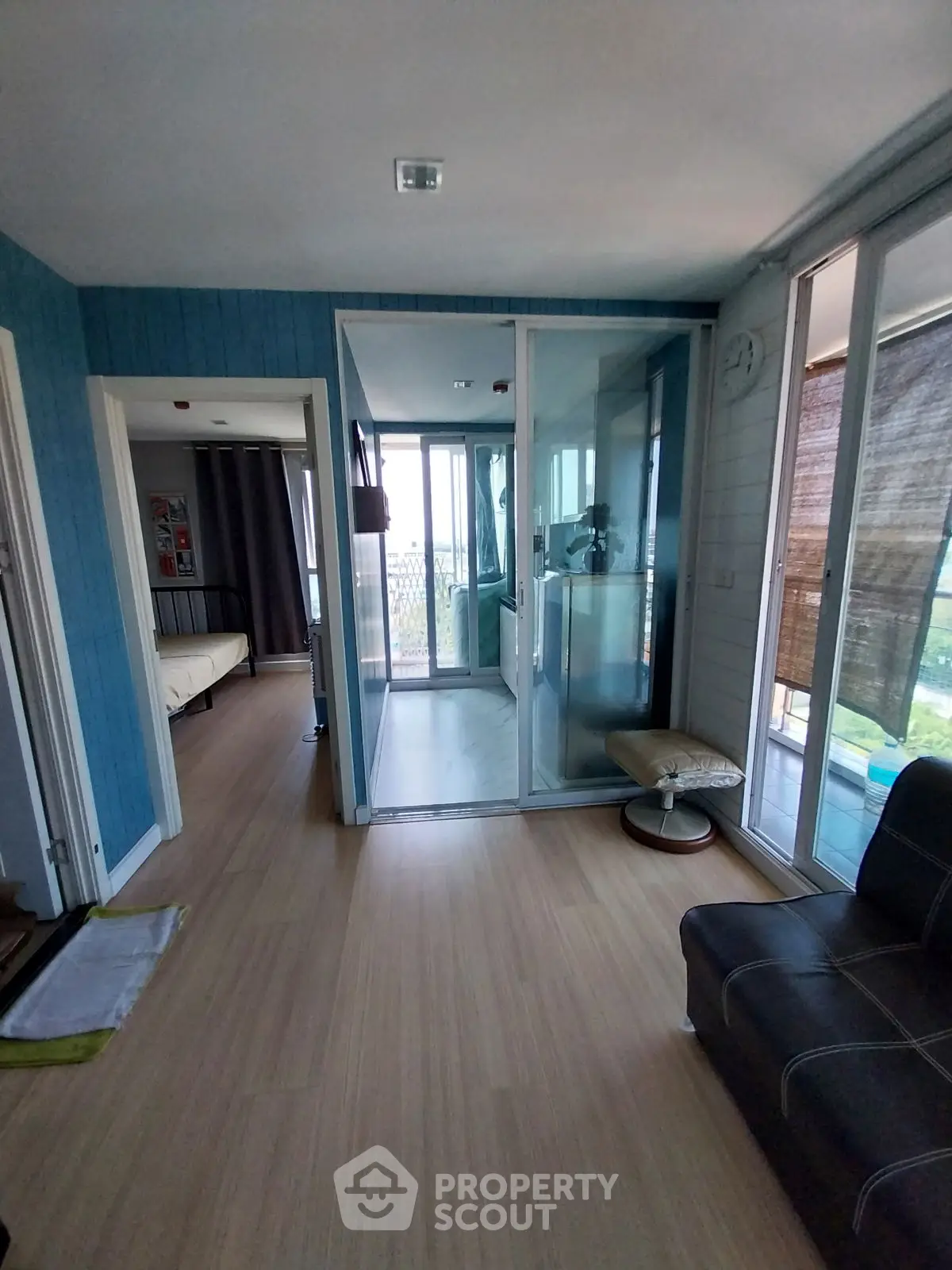 Spacious modern apartment with glass-enclosed balcony and wooden flooring