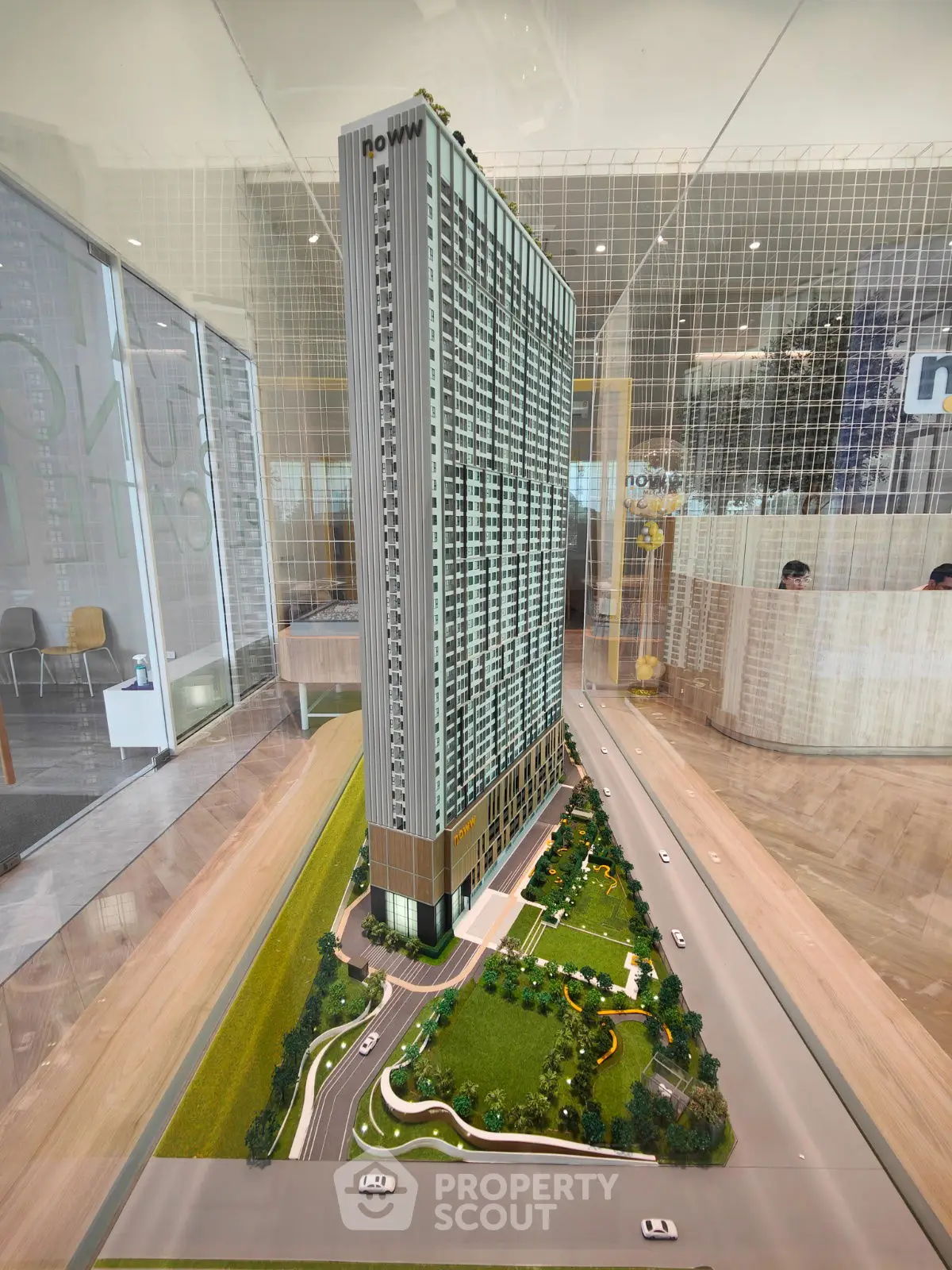 Stunning architectural model of a modern high-rise building with lush landscaping.