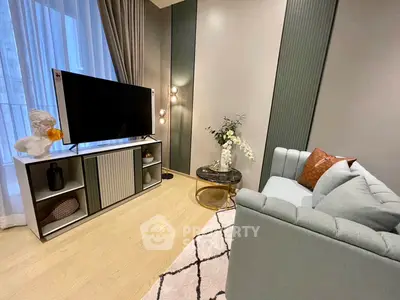 Stylish modern living room with elegant decor and large TV, perfect for relaxation and entertainment.