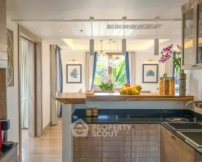 Luxurious open kitchen with modern design and elegant decor, featuring a breakfast bar and stylish lighting.