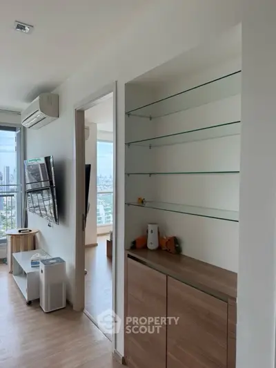 Modern apartment interior with built-in shelves and city view
