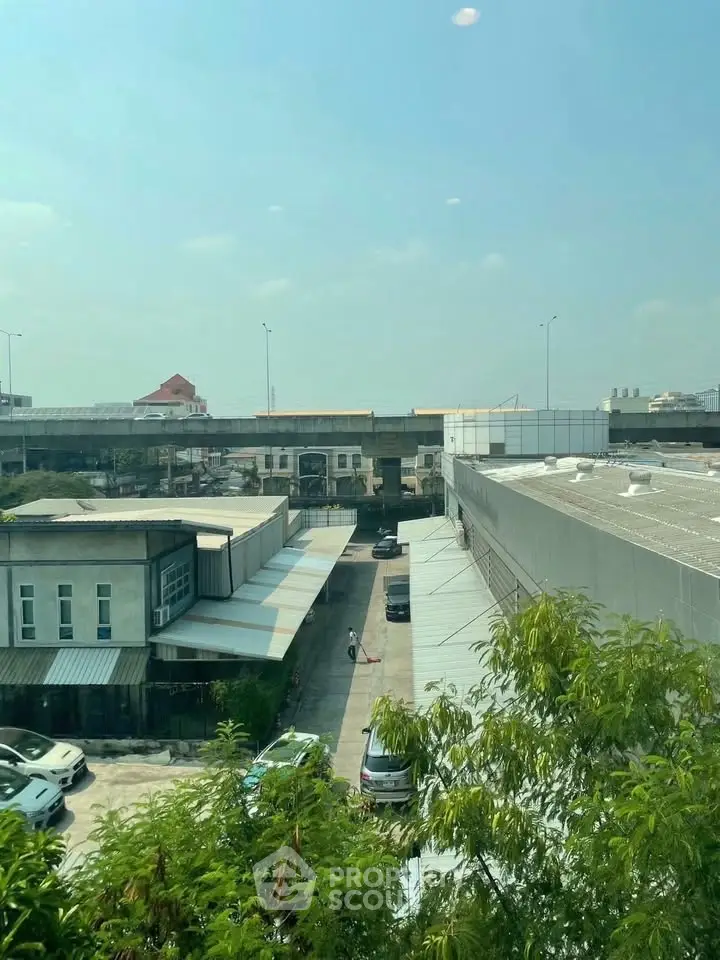 Urban industrial area with warehouses and parking, offering potential for commercial real estate investment.