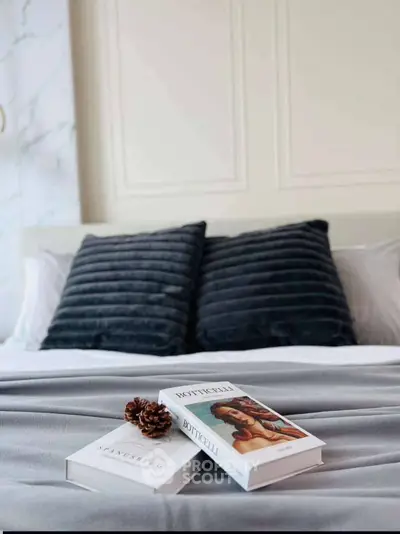 Cozy bedroom with elegant decor and plush pillows, perfect for relaxation.