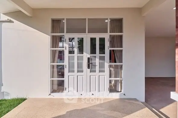 Elegant entrance with glass-paneled door and modern design, perfect for welcoming guests.