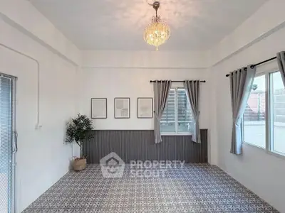 Spacious and elegant living room with chic decor and ample natural light.