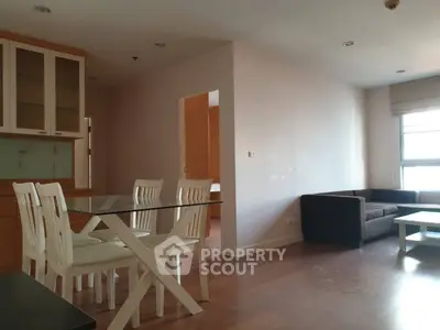 Spacious living room with dining area and natural light in modern apartment