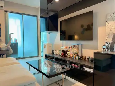 Modern living room with sleek black TV unit and glass coffee table