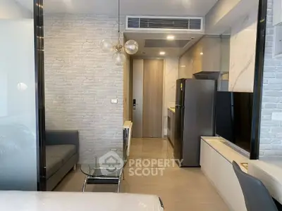 Modern studio apartment with sleek kitchen and stylish living area