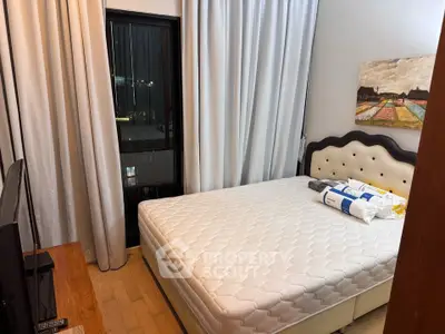 Cozy bedroom with elegant decor and large window offering city views, perfect for restful nights.
