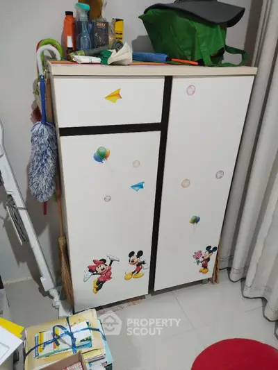 Charming children's room storage cabinet with playful Mickey Mouse design and colorful decorations.