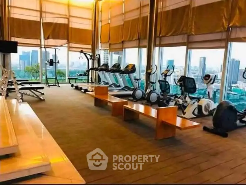 Luxurious high-rise gym with panoramic city views and modern fitness equipment.
