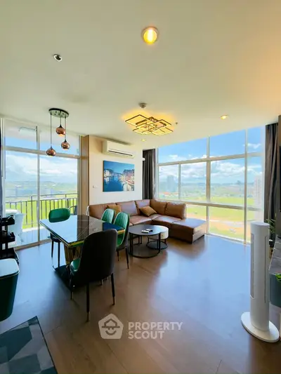 Spacious living room with large windows and modern furniture, offering a stunning view.