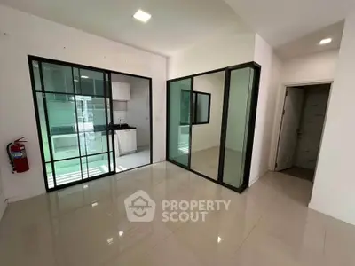 Modern interior with glass partitions and sleek kitchen design
