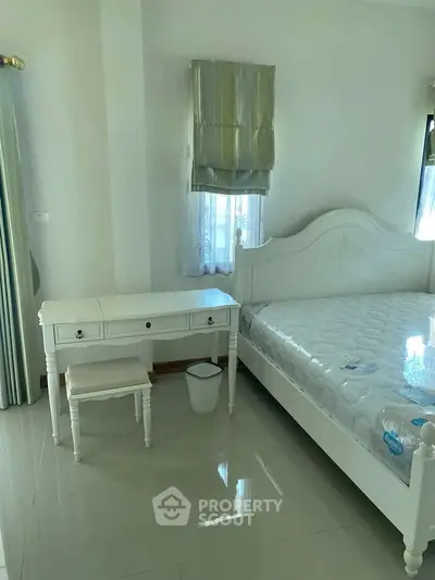 Bright bedroom with elegant white furniture and natural light