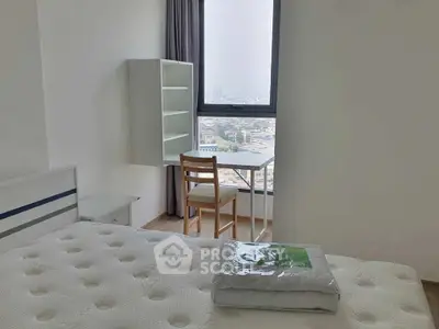 Bright bedroom with city view, featuring a cozy bed and a small study area by the window.