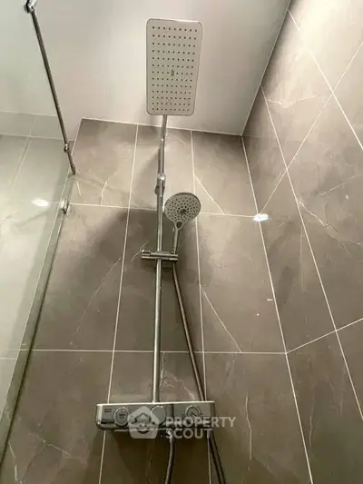 Modern bathroom shower with sleek tile design and dual shower heads.