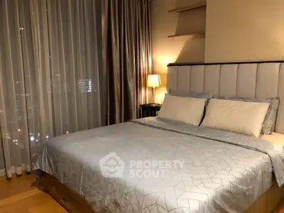 Luxurious bedroom with elegant curtains and ambient lighting in modern apartment.