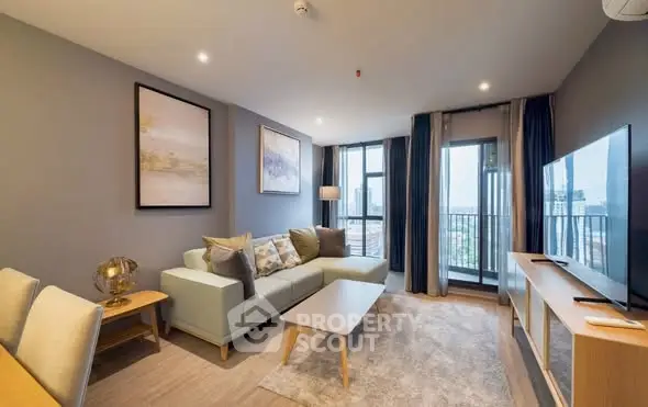 Modern living room with stylish decor and city view balcony.