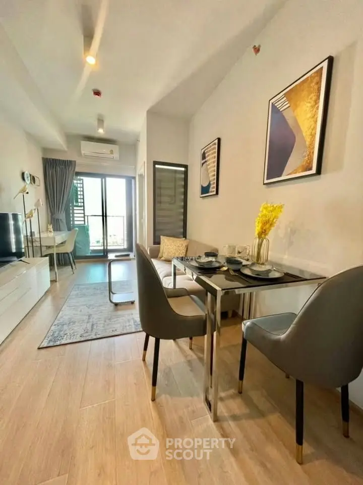 Modern living room with stylish decor and open layout, featuring elegant dining area and balcony access.