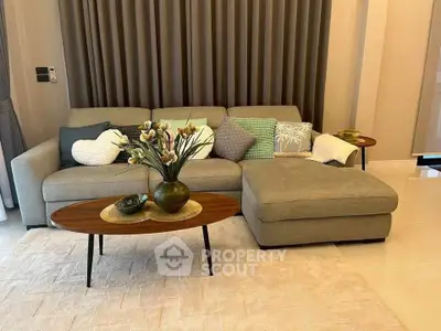 Elegant living room with modern sofa and stylish coffee table, perfect for cozy gatherings.