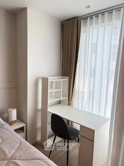Cozy bedroom corner with study desk and natural light, perfect for work-from-home setup.