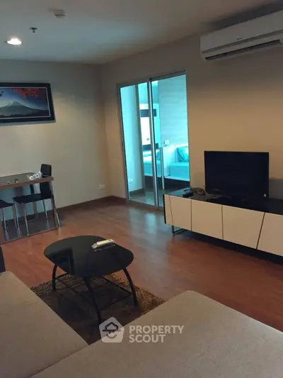 Modern living room with sleek furniture and wooden flooring in cozy apartment