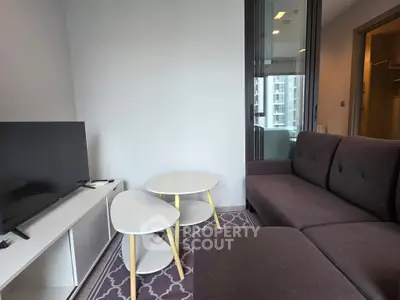 Modern living room with stylish furniture and city view, perfect for urban living.
