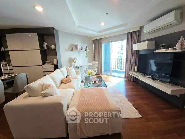 Spacious modern living room with elegant decor and balcony view