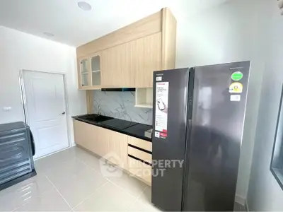 Modern kitchen with sleek appliances and stylish cabinetry in a bright, airy space.