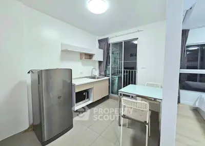 Modern compact kitchen with dining area and balcony view