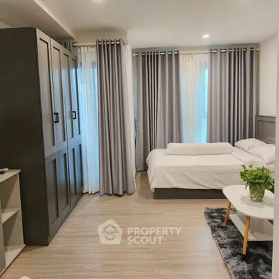 Modern bedroom with stylish decor and ample natural light