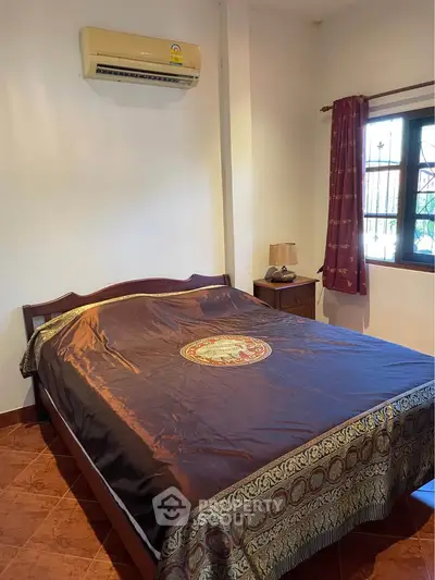 Cozy bedroom with air conditioning and elegant decor, perfect for a restful retreat.