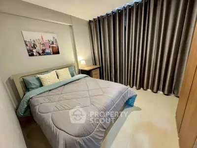 Cozy bedroom with modern decor and large window draped with elegant curtains, perfect for relaxation.