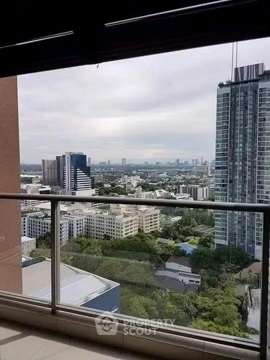 Stunning high-rise balcony view overlooking cityscape with modern skyscrapers and lush greenery.