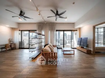 Spacious modern living room with city view and stylish wooden flooring.