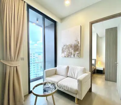 Modern living room with cozy sofa and large window offering city view
